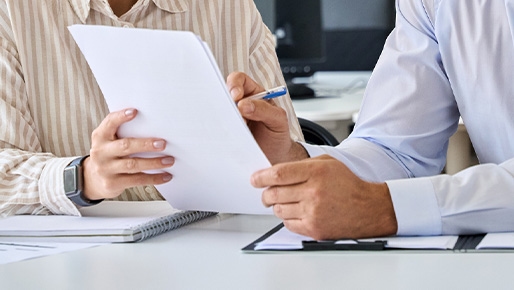 two people looking over paperwork
